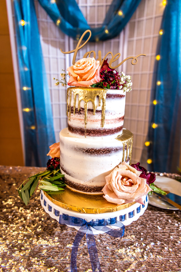 Tiered unique wedding cake with gold dripping from the tiers
