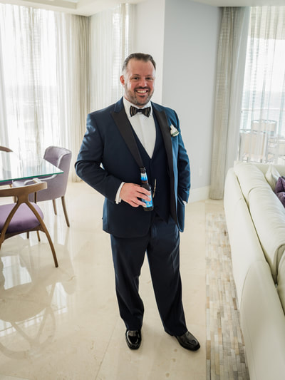 Groom posing with a beer