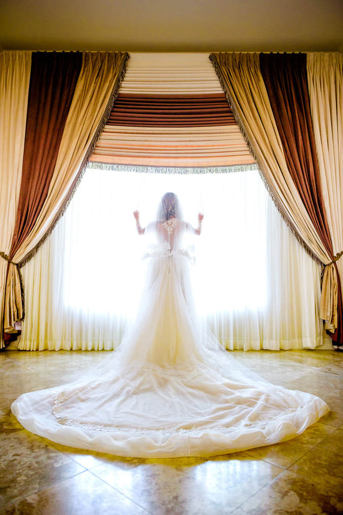 Bride posing in front of a window