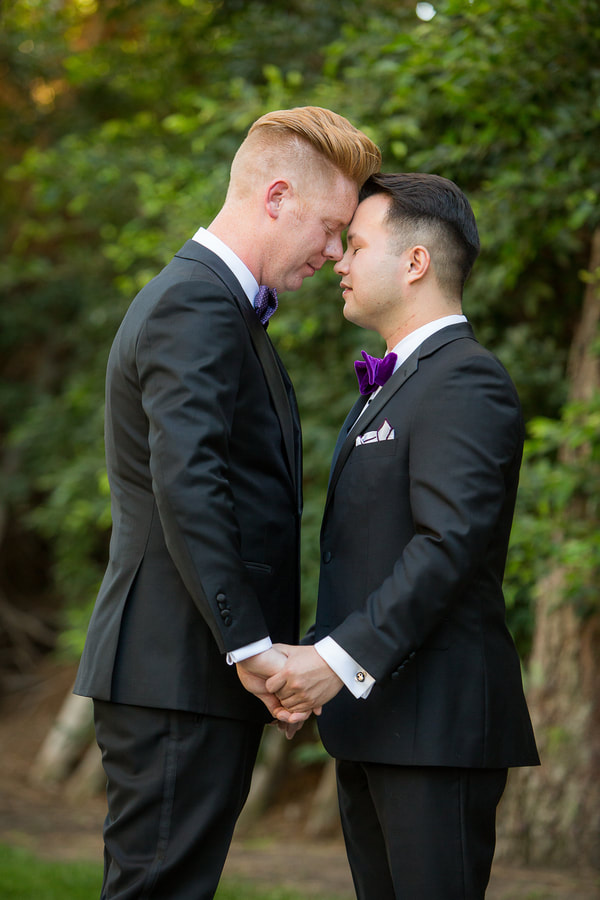 Grooms embracing each other