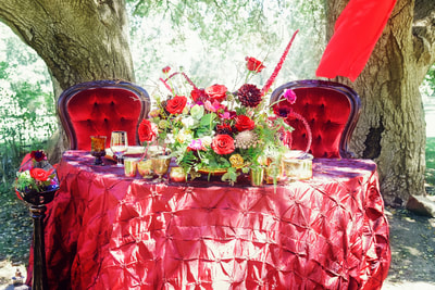sweetheart table in red velvet with red centerpiece