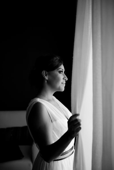 B&W bride looking out a window