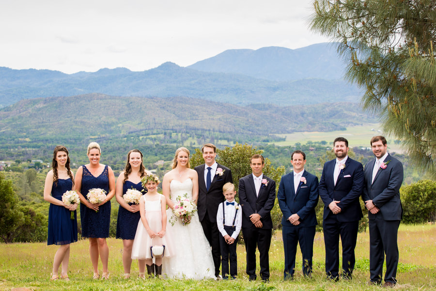 Bridal party and groomsmen posing with children