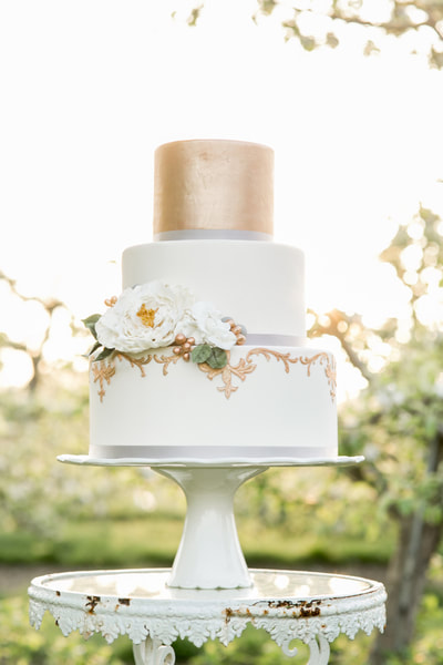 Tiered wedding cake with gold top